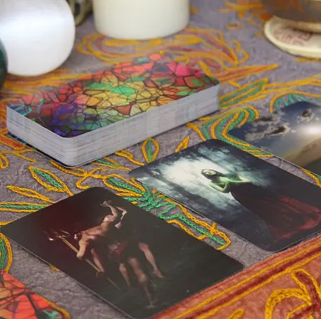 A table with tarot cards and candles on it.